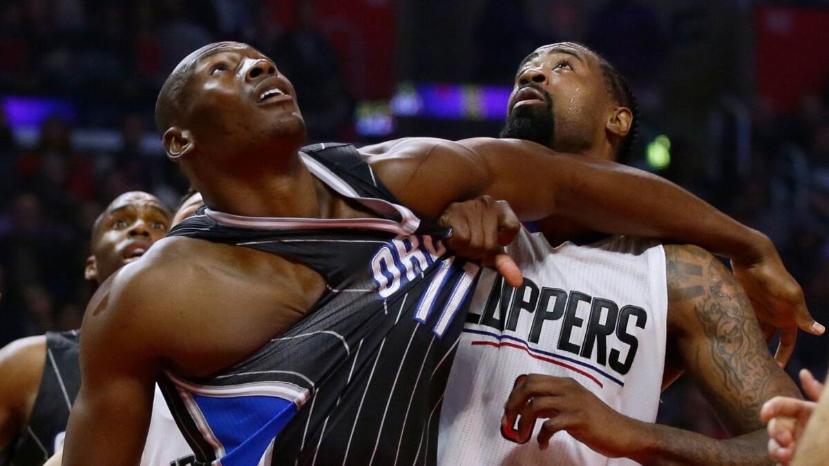 Clippers center DeAndre Jordan wrestles for position against Magic center Bismack Biyombo on Wednesday night.