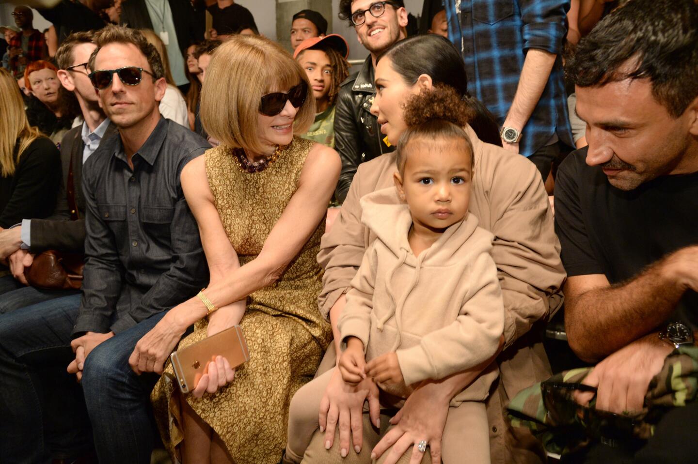 From left: Seth Meyers, Anna Wintour, Kim Kardashian West and North West attend the show for the Kanye West Yeezy collection at Skylight Modern on Sept. 16 during New York Fashion Week.