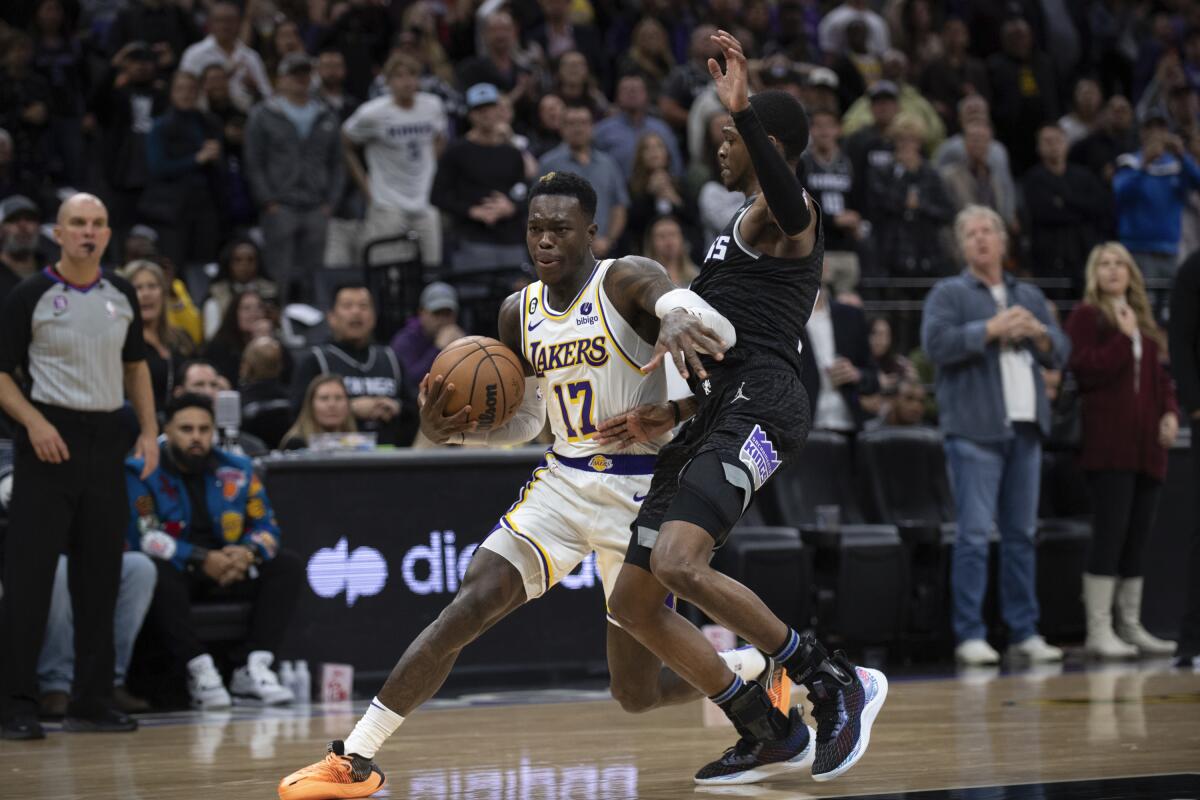 The Lakers' Dennis Schroder is fouled by the Kings' De'Aaron Fox during the second half Jan. 7, 2023.