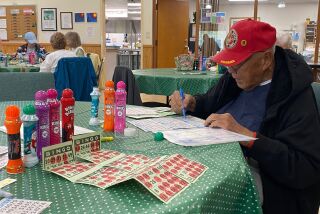 Peter Ventura Jr. preps for bingo at the Senior Center.