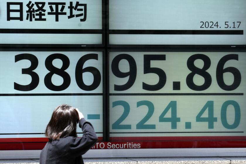 A person looks at an electronic stock board showing Japan's Nikkei 225 index at a securities firm Friday, May 17, 2024, in Tokyo. (AP Photo/Eugene Hoshiko)