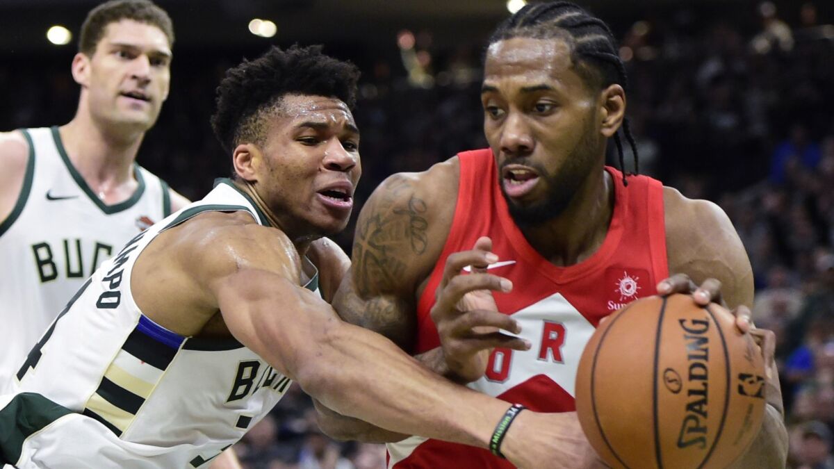 Raptors forward Kawhi Leonard drives past Bucks forward Giannis Antetokounmpo during Game 5 of the Eastern Conference finals series.