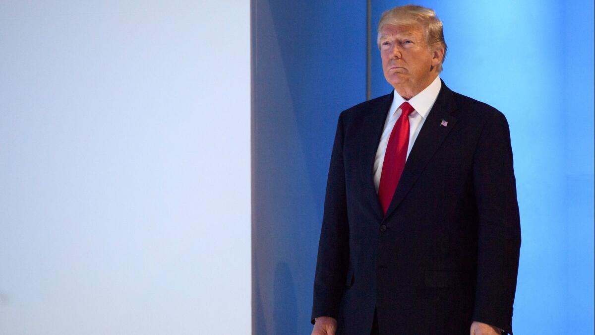 President Trump arrives at a session of the annual meeting of the World Economic Forum in Davos, Switzerland, on Friday, under a cloud of new controversy back in the United States.