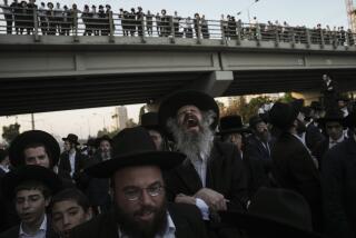 Ultra-Orthodox Jewish men block a highway during a protest against army recruitment in Bnei Brak, Israel, Thursday, June 27, 2024. Israel's Supreme Court unanimously ordered the government to begin drafting ultra-Orthodox Jewish men into the army — a landmark ruling seeking to end a system that has allowed them to avoid enlistment into compulsory military service. (AP Photo/Oded Balilty)