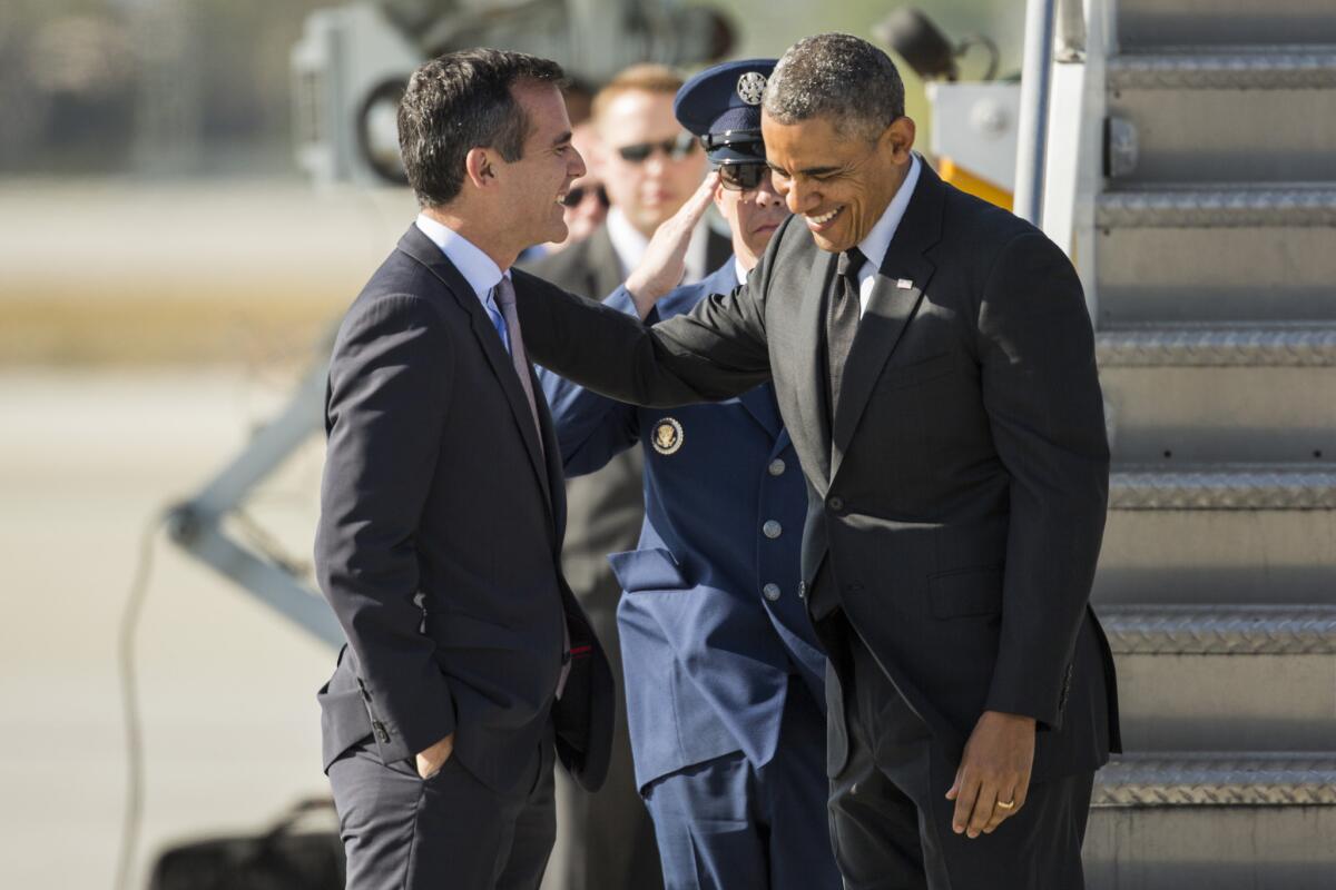 President Barack Obama greets Los Angeles Mayor Eric Garcetti as he arrives at LAX.