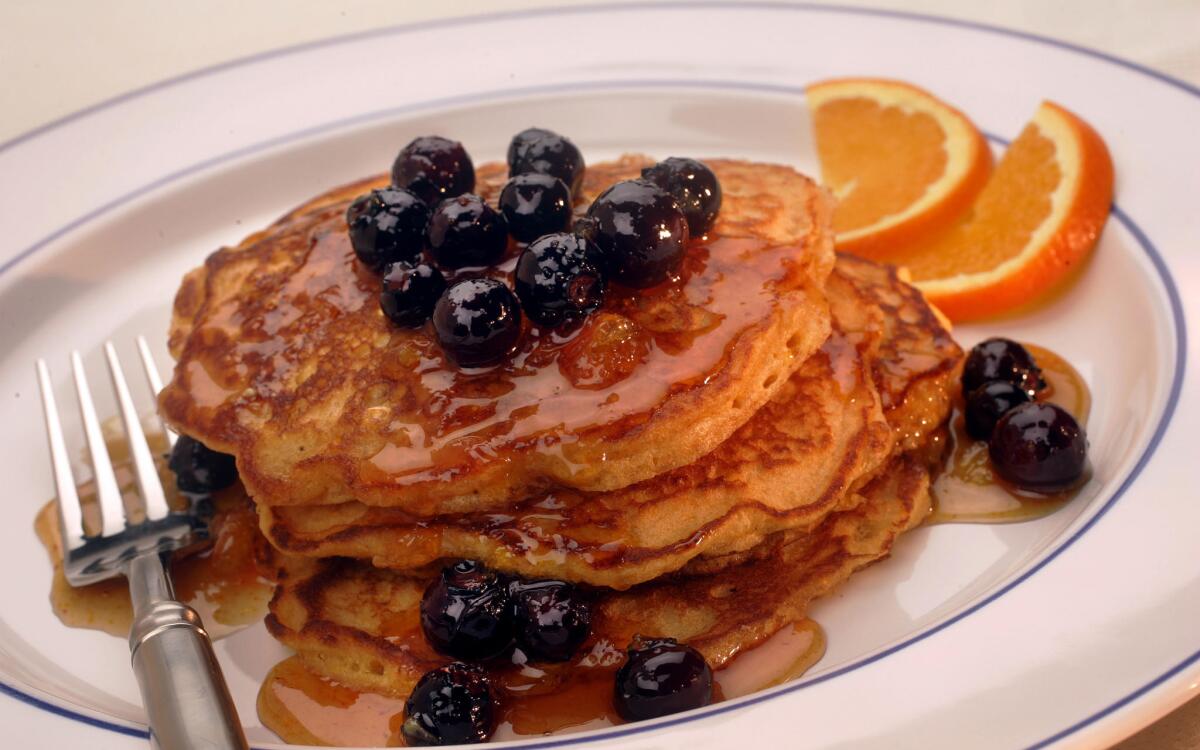 Malted cornmeal pancakes with orange-blueberry syrup