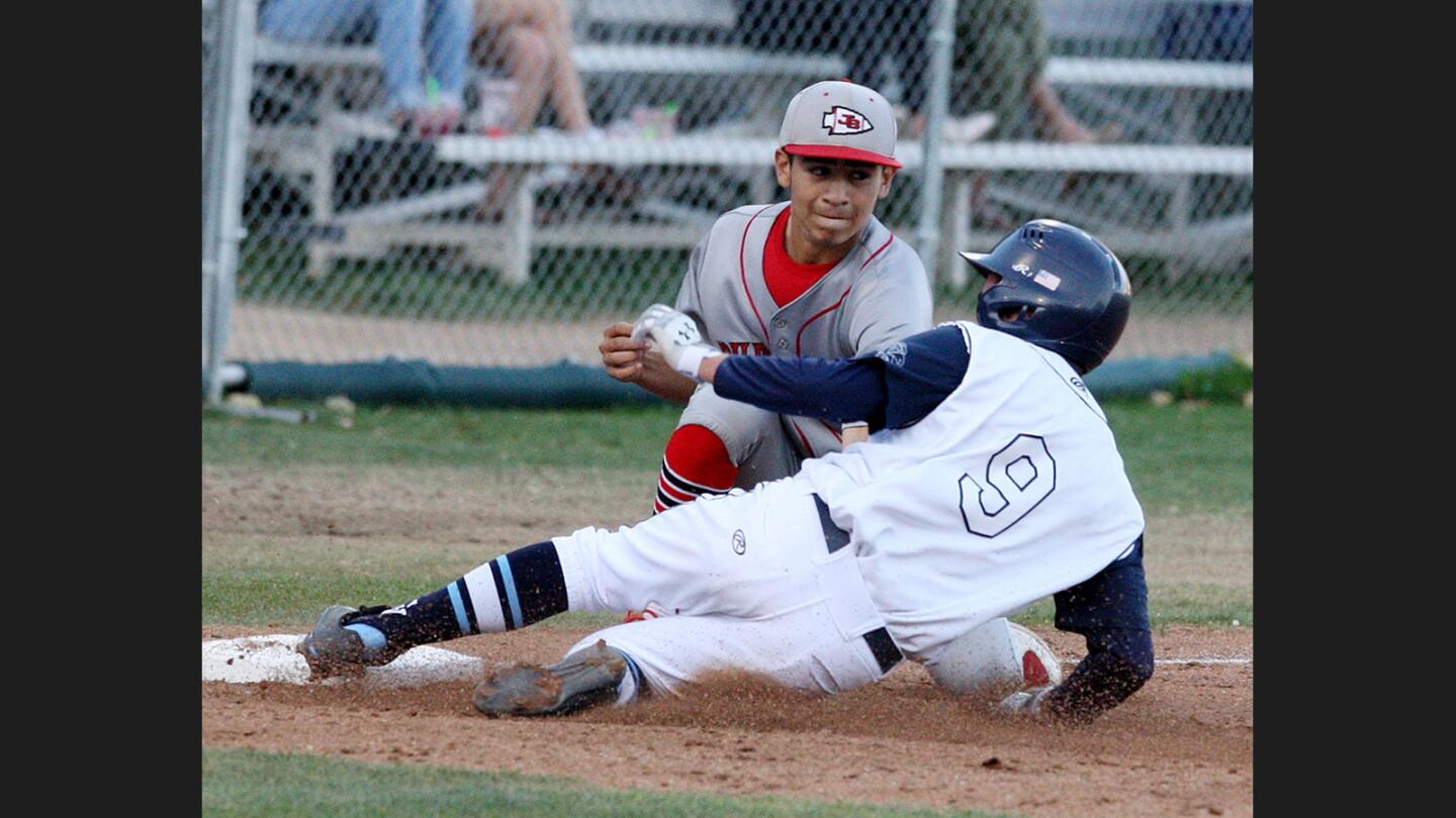 Burroughs’ Ricky Perez tags out Crescenta Valley’s Nico Arredondo for the first out in a double play in a Pacific League baseball game at Stengel Field in Glendale on Tuesday, May 2, 2017.