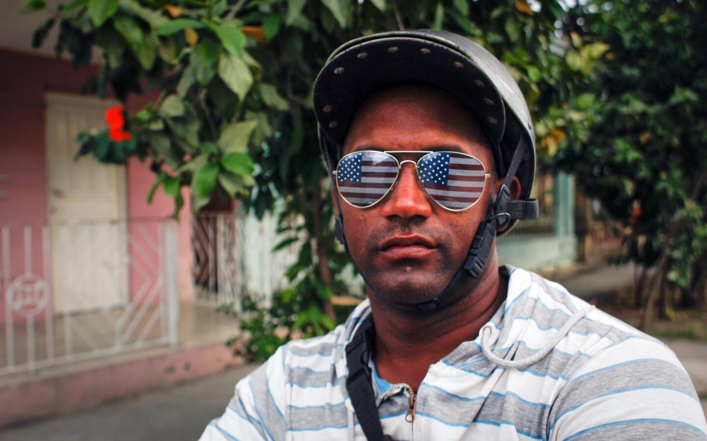 A man wears sunglasses with the U.S. flag in a street of Guantanamo, Cuba, on March 12, 2016.