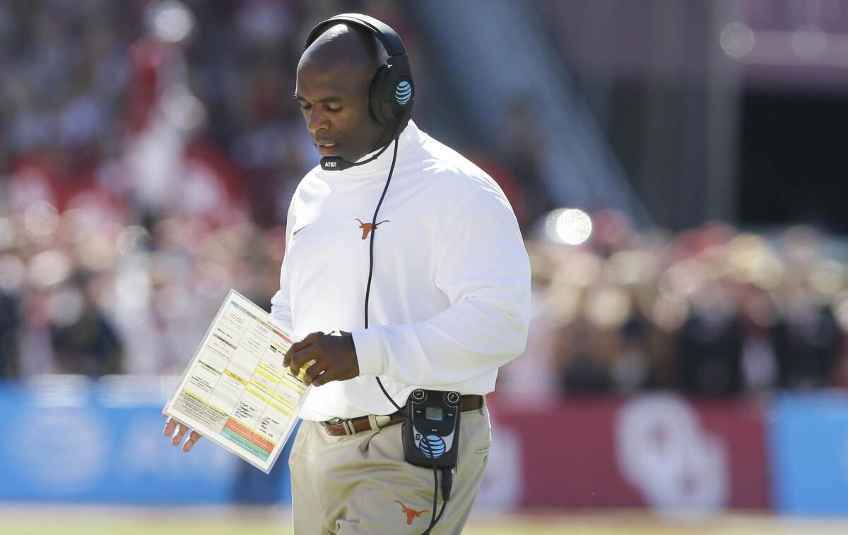 Texas Coach Charlie Strong walks the sidelines during the first half of a game against Oklahoma in Dallas on Oct. 8.