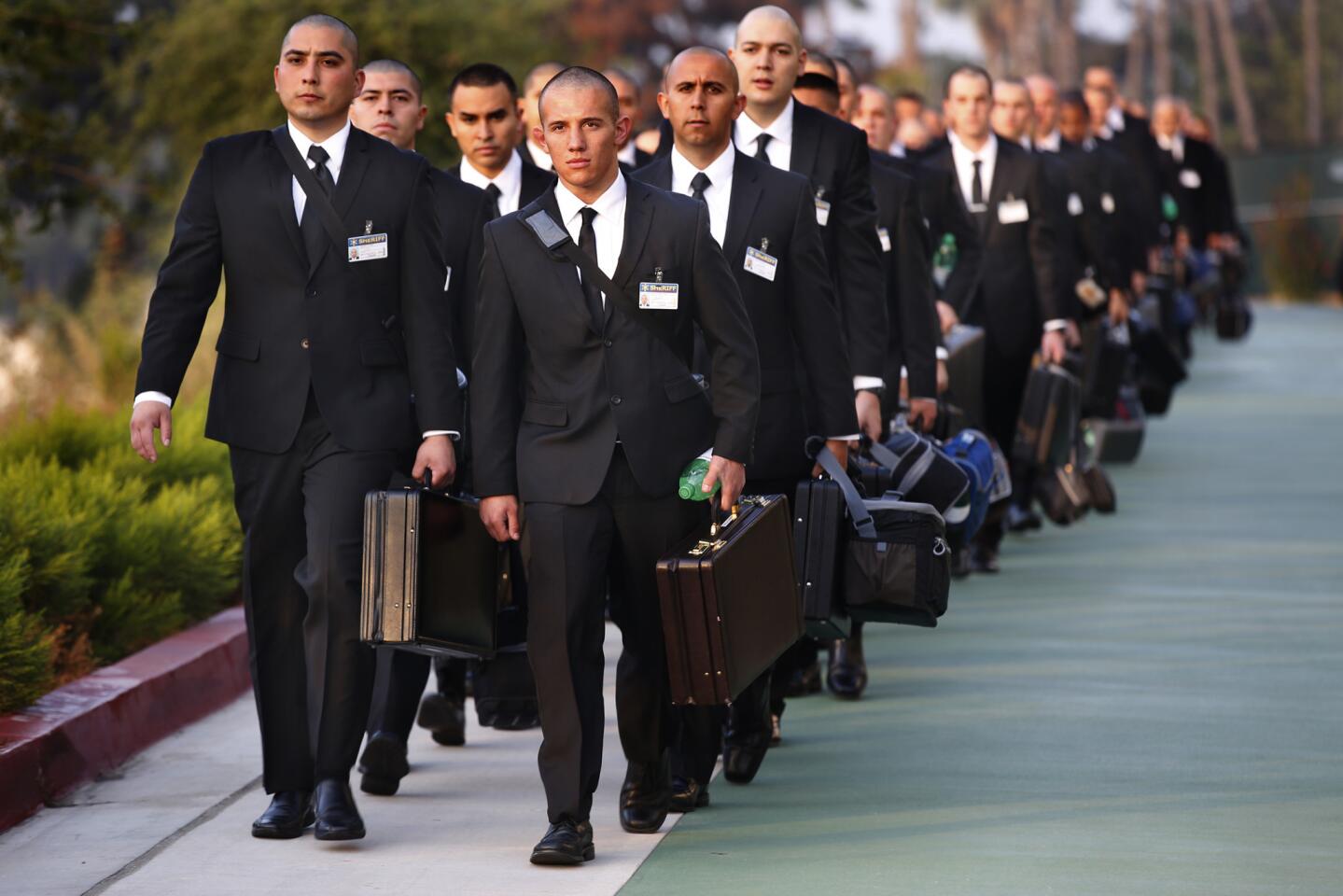 Los Angeles County Sheriff's Department recruits arrive for the first day of academy at the Biscailuz Training Center in Monterey Park all dressed in black suits, for "Black Monday." After a brief classroom session drill instructors begin the yelling, and the class assembles on the "Grinder" for exercises and training.