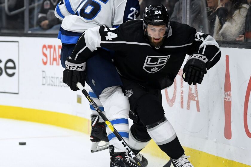 LOS ANGELES, CA - DECEMBER 18: Derek Forbort #24 of the Los Angeles Kings avoids a check from Blake Wheeler #26 of the Winnipeg Jets at Staples Center on December 18, 2018 in Los Angeles, California. (Photo by Harry How/Getty Images) ** OUTS - ELSENT, FPG, CM - OUTS * NM, PH, VA if sourced by CT, LA or MoD **