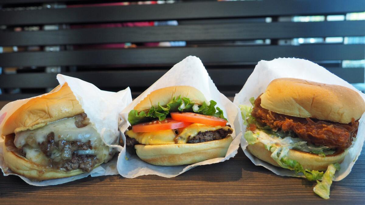From left, the Roadside Double burger, the ShackBurger and the Chick'n Shack from the new Shake Shack in West Hollywood.