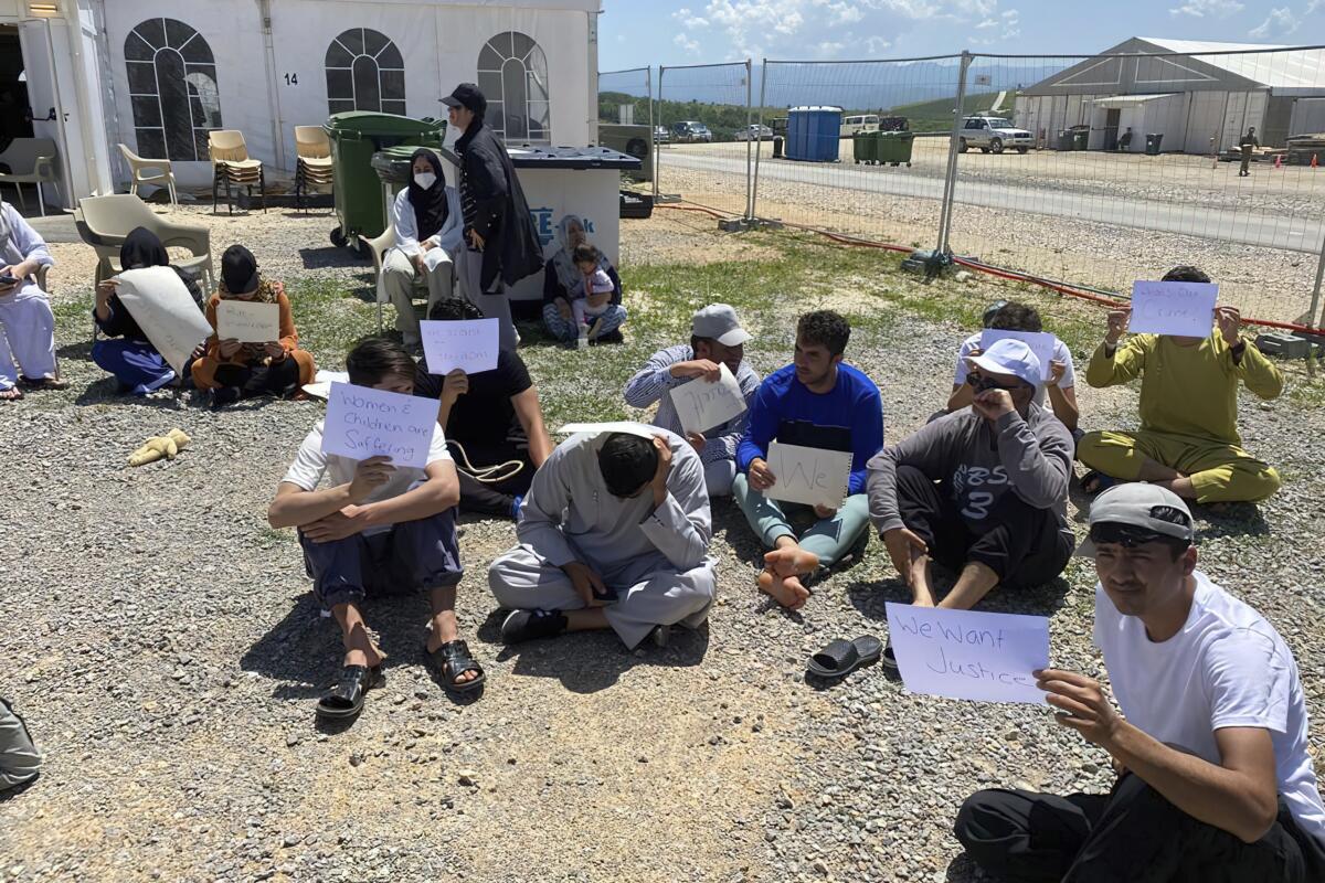 Afghans who fled the Taliban takeover of their country stage a protest at Camp Bondsteel in Kosovo on Wednesday