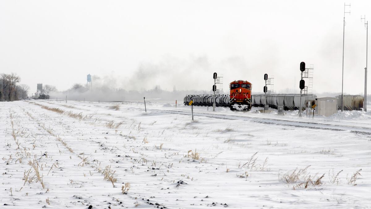 Crude oil tanker cars continue to burn at the site of a train collision in Casselton, N.D. No one was hurt in Monday's derailment.