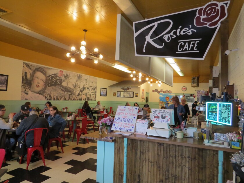 A sign and donation bucket near the cash register at Rosie's Cafe in Escondido on Monday raises awareness and money for owner Kaitlyn Rose Pilsbury, 33, who was seriously injured Dec. 21 in a hit-and-run accident in Vista.