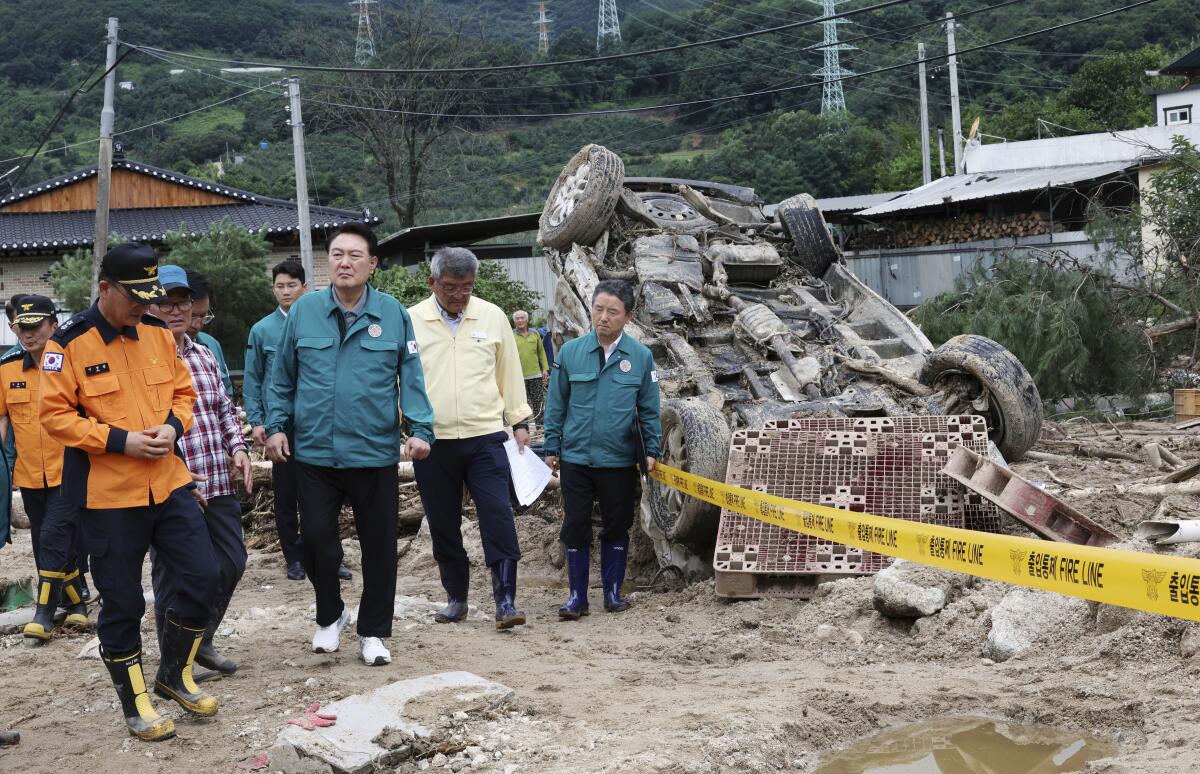 South Korea's president and others surveying flood damage