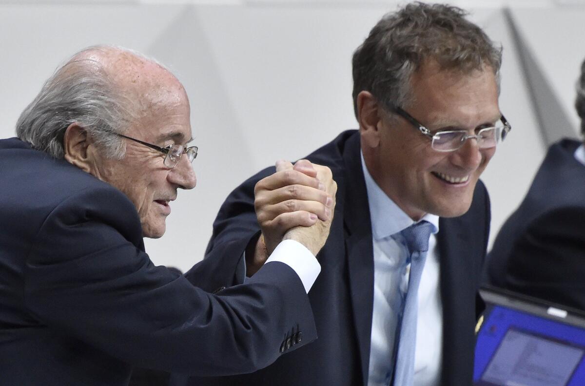 FIFA President Sepp Blatter shakes hands with FIFA General Secretary Jerome Valcke, right, during the 65th FIFA Congress in Zurich, Switzerland, on May 29.