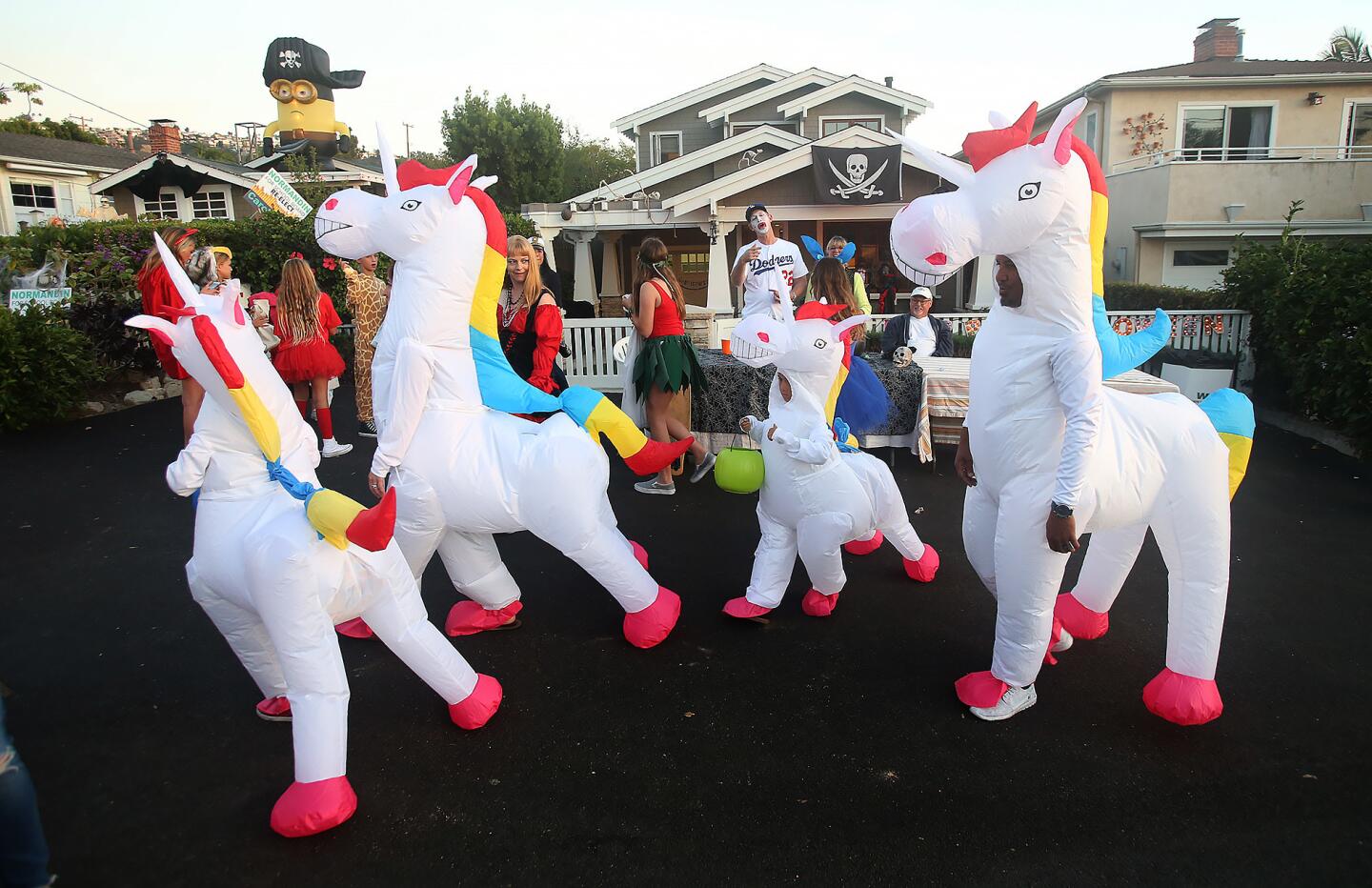 Dressed as unicorns, members of the Zaki family walk during the annual Oak Street Halloween block party and costume parade on Wednesday in Laguna Beach.