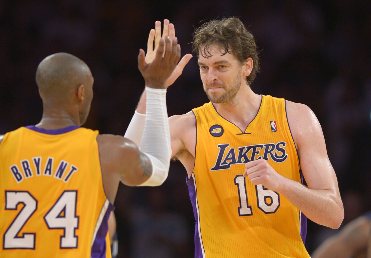 Lakers forward Pau Gasol and guard Kobe Bryant exchange a high-five.