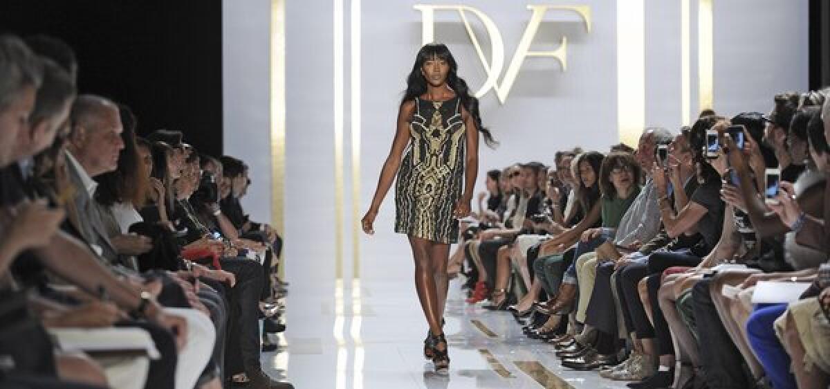 Naomi Campbell presents a creation from the spring 2014 collection by Diane von Furstenberg during Fashion Week in New York.