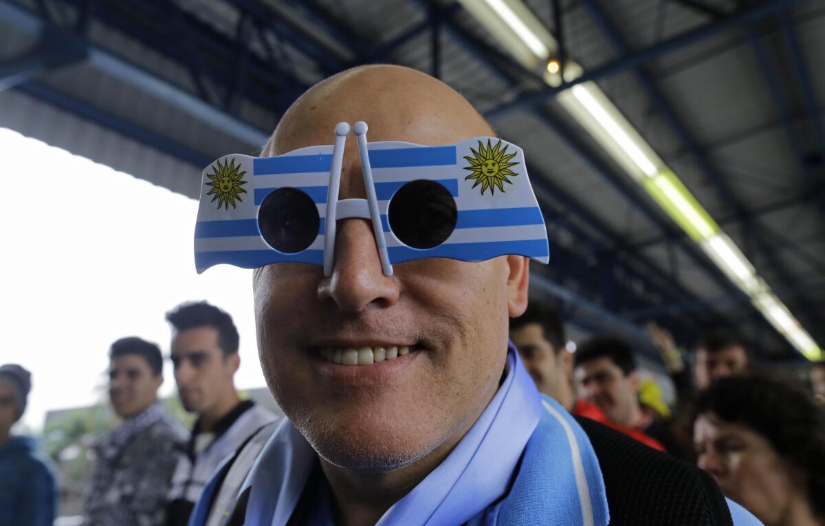 Sunglasses can be fun. Here a soccer fan sports a pair of Uruguayan flag-designed sunglasses as he attends a World Cup soccer match between Uruguay and England in Sao Paulo, Brazil.