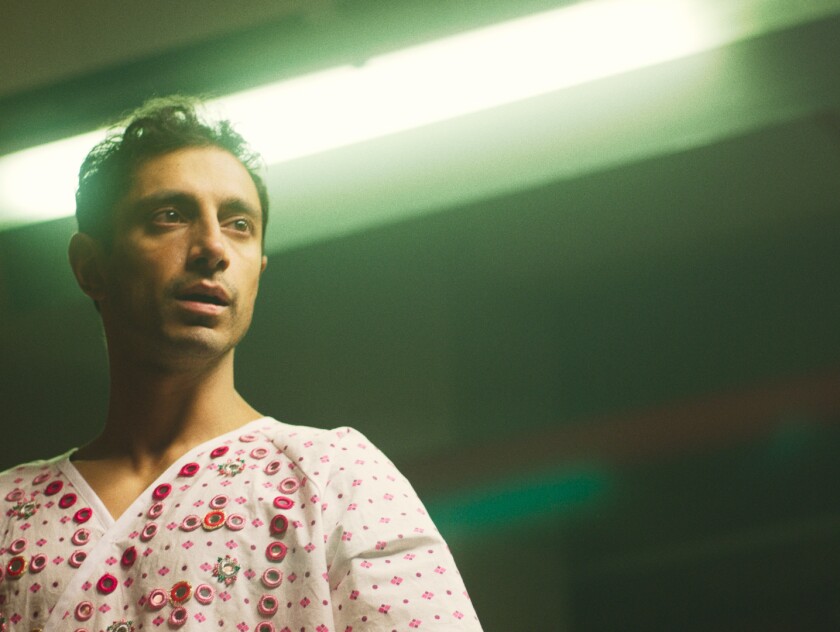 Riz Ahmed in a colorfully decorated hospital gown in the movie “Mogul Mowgli”