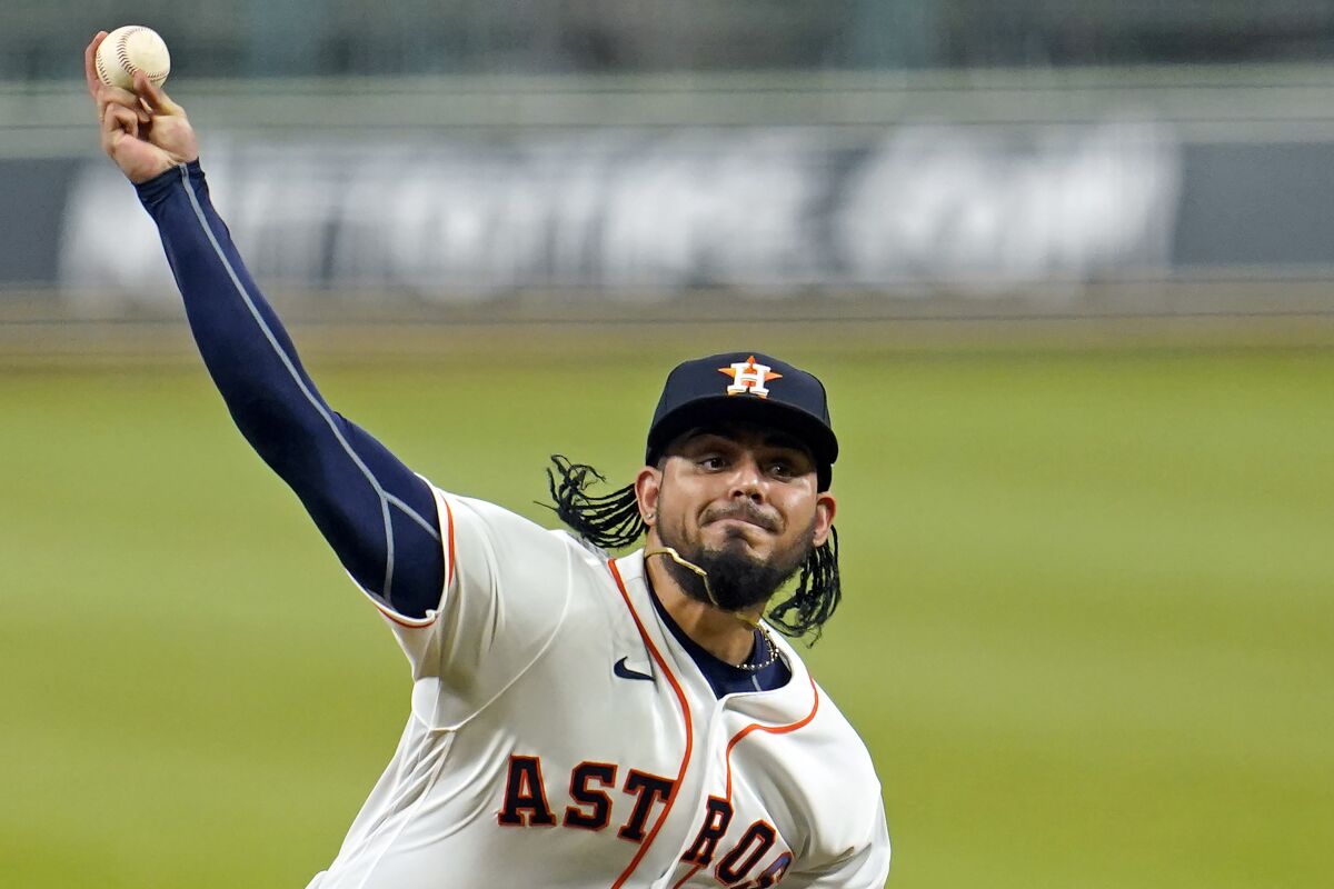 FILE - Houston Astros relief pitcher Roberto Osuna throws during the ninth inning of a baseball game against the Seattle Mariners on July 27, 2020, in Houston. Osuna has signed with Japanese club Chiba Lotte Marines, the team has confirmed. (AP Photo/David J. Phillip, File)