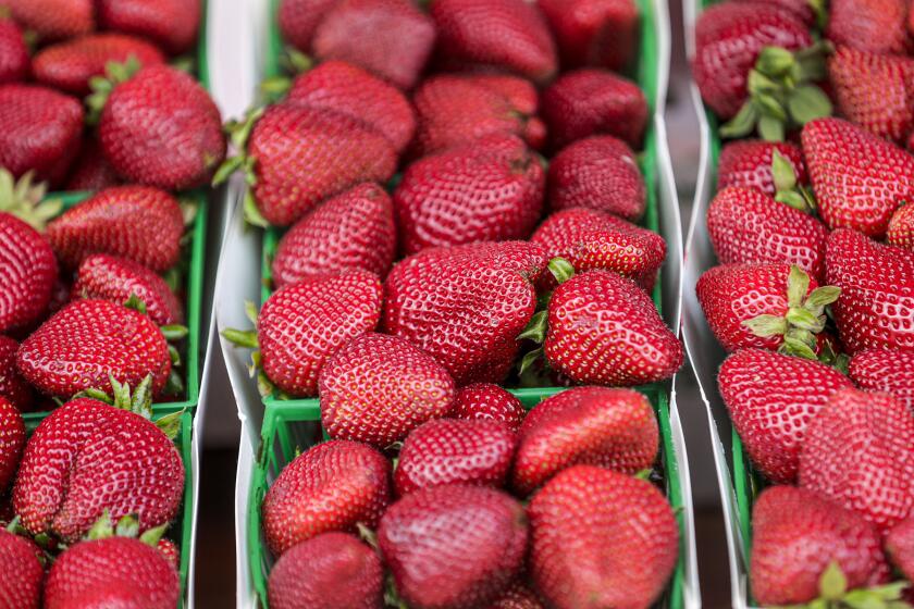 SANTA MONICA, CA - APRIL 18: A strawberry stand at Santa Monica Farmers Market. Due to coronavirus pandemic everyone customers as well as must observe social distancing, wear a mask and gloves. Santa Monica, CA. (Irfan Khan / Los Angeles Times)