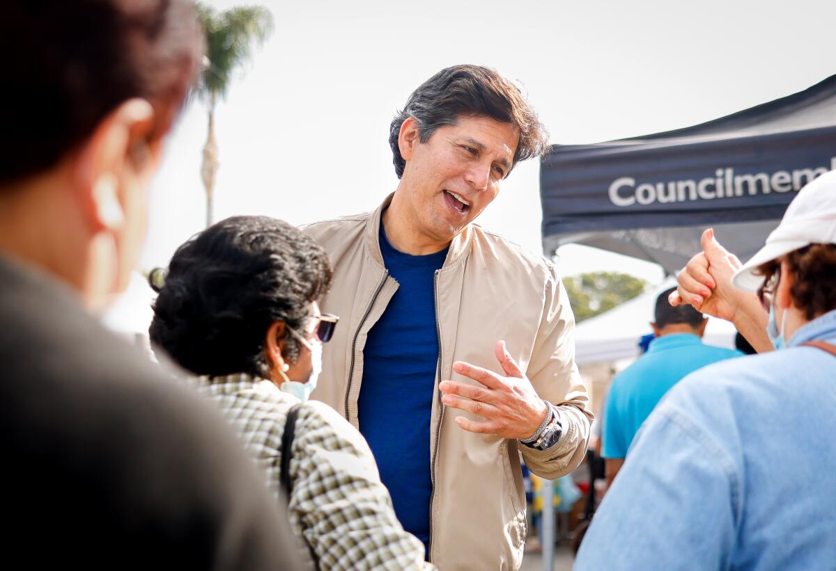 Councilmember Kevin de León greets people at a food distribution event outside his Eagle Rock office in September.