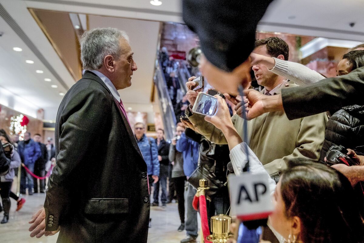 FILE - Carl Paladino, left, speaks to members of the media at Trump Tower, on Dec. 5, 2016, in New York. Paladino, a Republican running for Congress in western New York, said he was wrong to invoke Adolf Hitler in an interview last year. (AP Photo/Andrew Harnik, File)