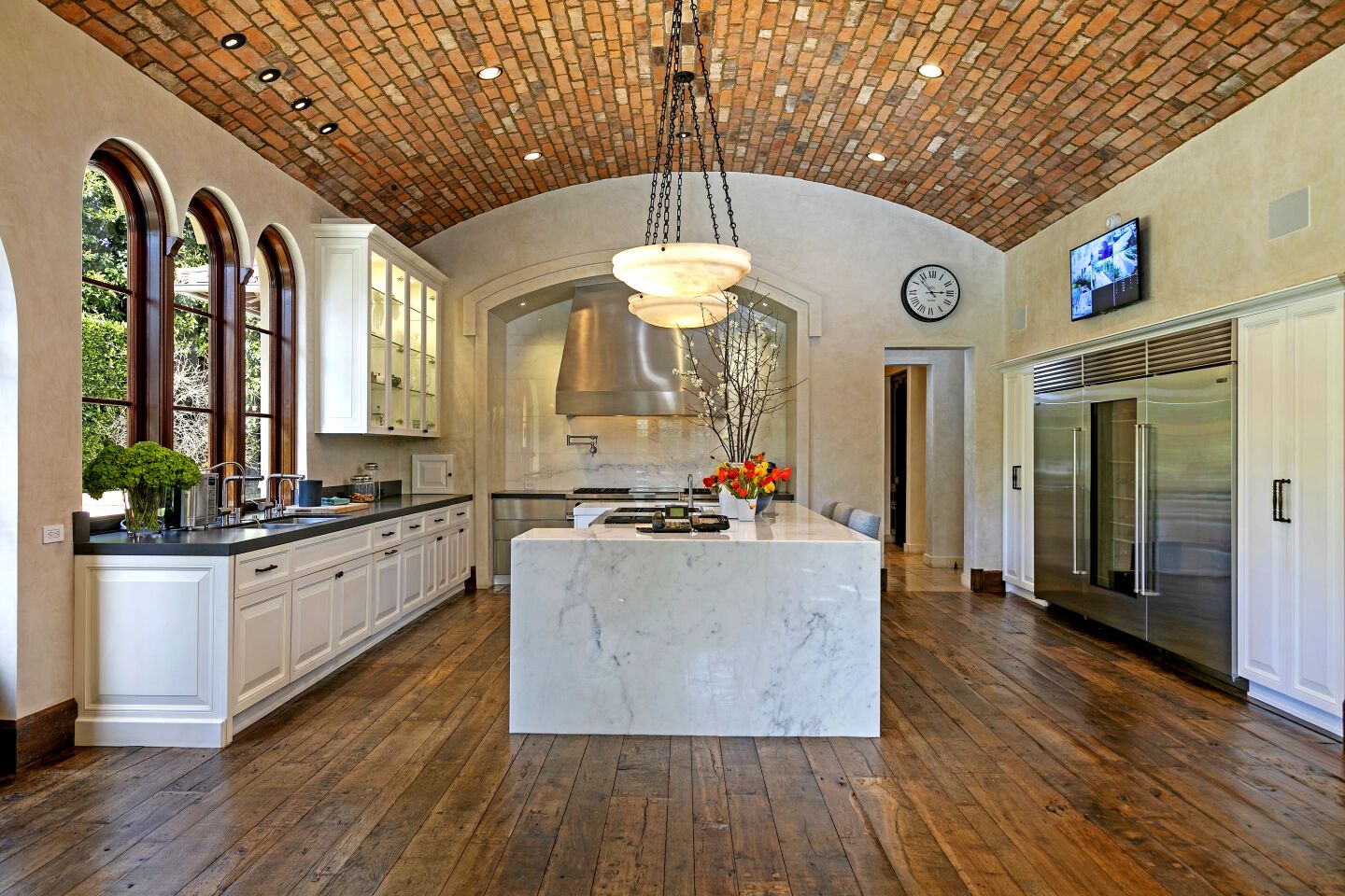 The chef's kitchen is topped by a brick barrel ceiling.