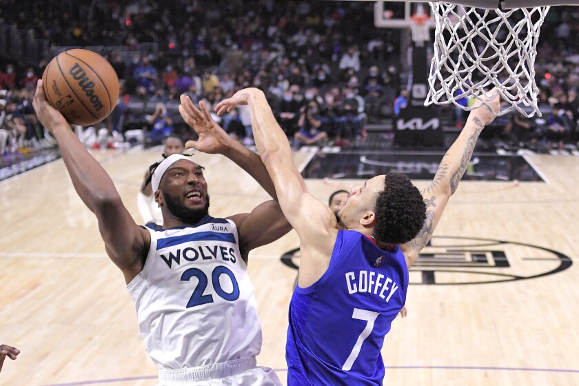 Minnesota Timberwolves forward Josh Okogie, left, shoots as Los Angeles Clippers guard Amir Coffey defends during the second half of an NBA basketball game Monday, Jan. 3, 2022, in Los Angeles. (AP Photo/Mark J. Terrill)