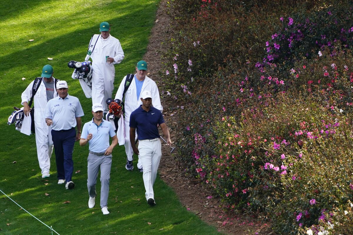 Fred Couples, left, Justin Thomas and Tiger Woods walk down the sixth fairway during a practice round for the Masters golf tournament on Monday, April 4, 2022, in Augusta, Ga. (AP Photo/Matt Slocum)