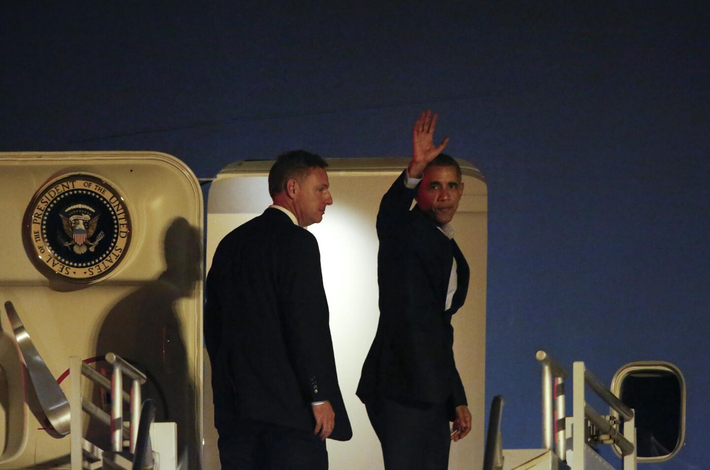 President Obama waves as he boards Air Force One at LAX to depart Los Angeles on Saturday night.