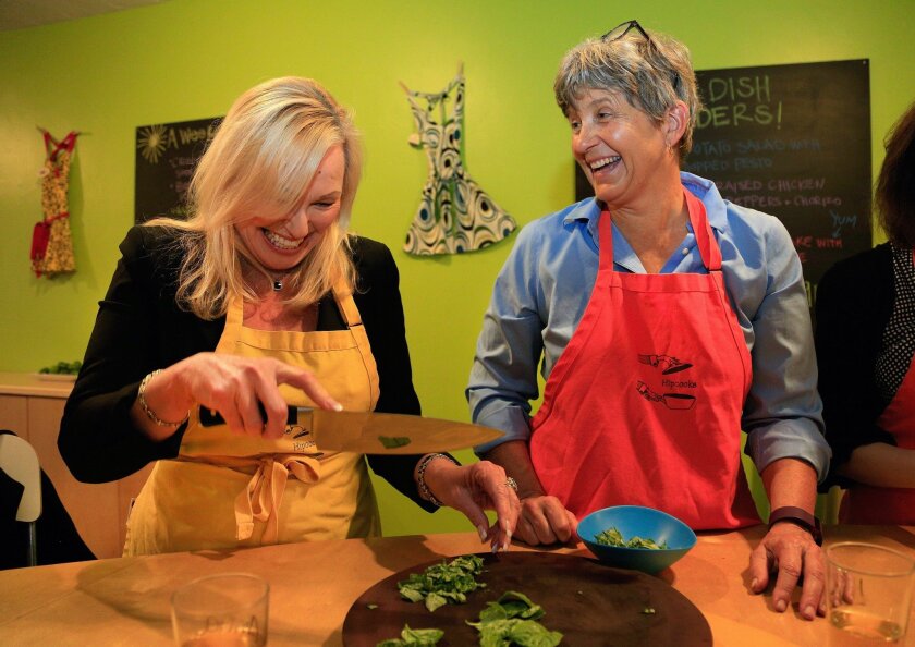 Anna Stinson, left, and Liz Harley sharpen up their knife skills during a healthy-cooking class at Hipcooks in North Park.
