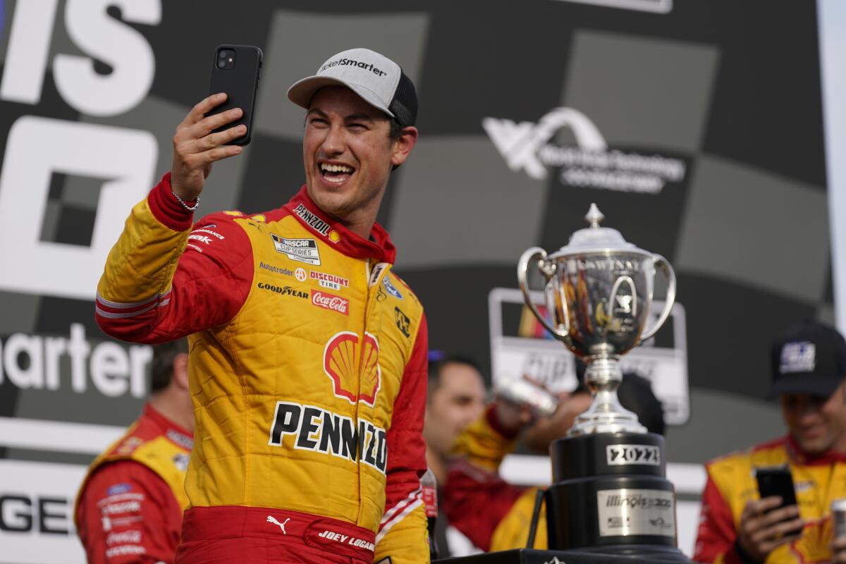 Joey Logano celebrates after winning a NASCAR Cup Series auto race.
