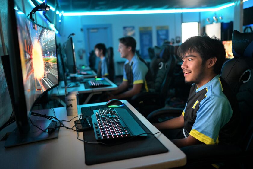 Reuben Estrada reacts while sitting at a school computer during an e-sports competition at Quartz Hills High 