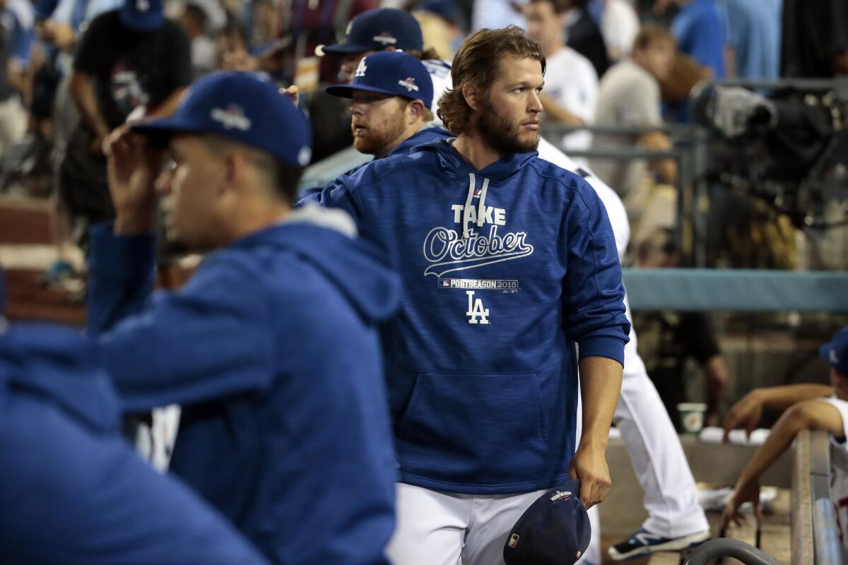Despondant Dodgers, including pitcher Clayton Kershaw, watch as the Mets celebrate their series-clinching 3-2 win in Game 5 of the NLDS.