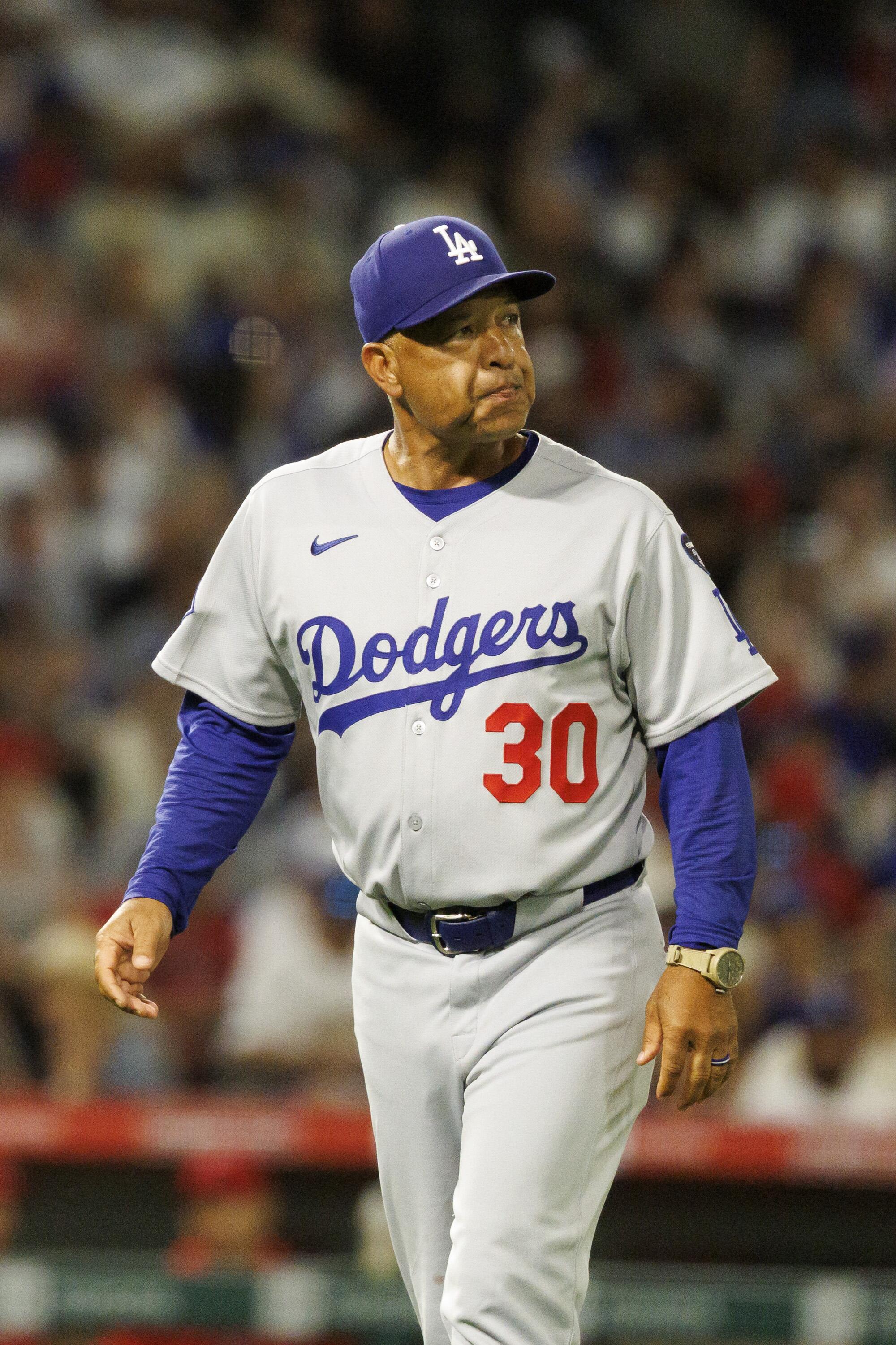 Yoshinobu Yamamoto rocked by Zach Neto and Angels as Dodgers' NL West lead falls to 1 2 Dodgers manager Dave Roberts walks off the field after pulling Yoshinobu Yamamoto from the game.
