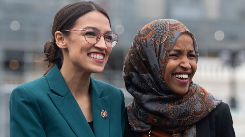 Rep. Alexandria Ocasio-Cortez, left, and Rep. Ilhan Omar attend a press conference calling on Congress to cut funding for Immigration and Customs Enforcement on Feb. 11.