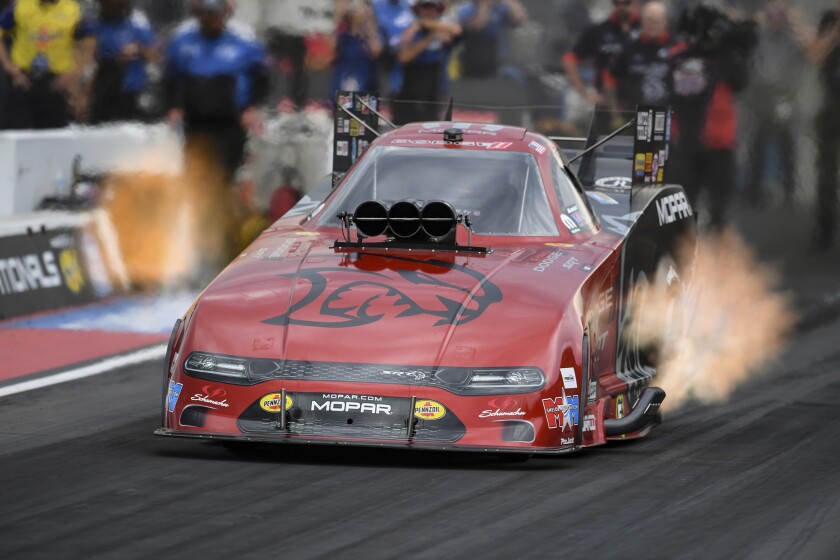 In this photo provided by the NHRA, Matt Hagan drives in Funny Car qualifying on Saturday, July 17, 2021, at Bandimere Speedway in Morrison, Colo. Hagan's run at 3.966 seconds and 319.22 mph Friday held up for the No. 1 spot in qualifying. (Jerry Foss/NHRA via AP)