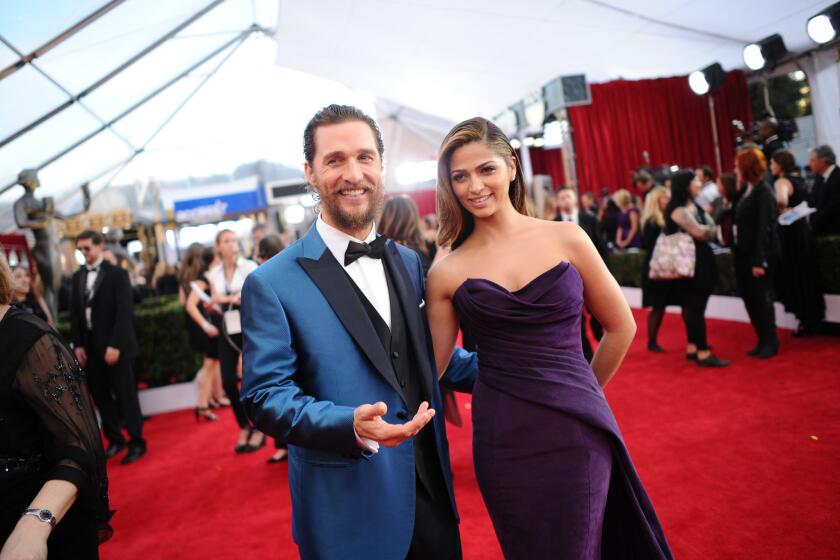 Matthew McConaughey and wife Camila Alves, wearing a Donna Karan gown, arrive at the Screen Actors Guild Awards on Jan. 25, 2015.