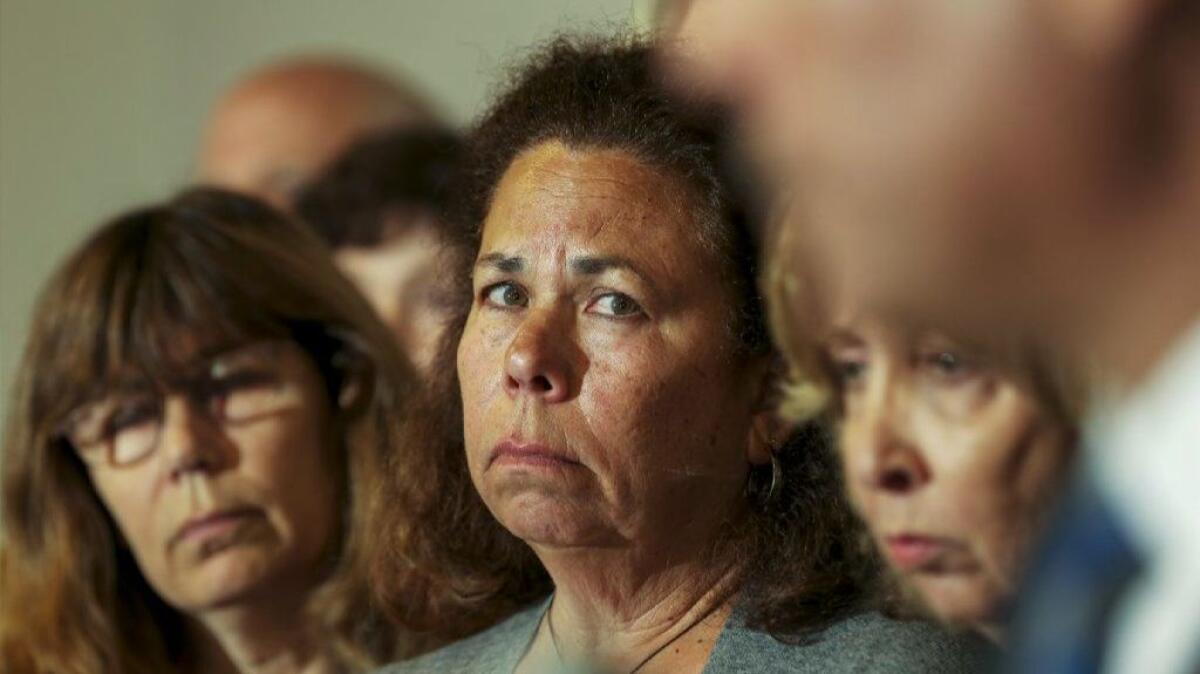 Sheryl Tidus, center, is flanked by other family members at a news conference held in April to publicize a $100,000 reward in the killing of her husband, Jeffrey Tidus.