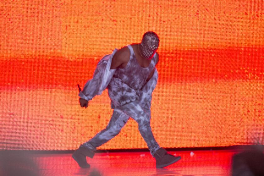 Kanye West performs in a mask on the main stage at the Wireless Festival in London on July 4.