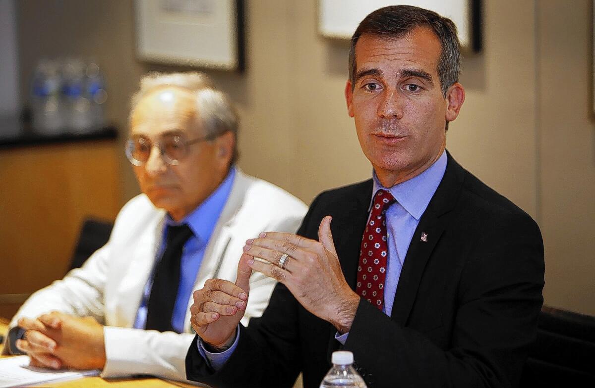 Los Angeles Mayor Eric Garcetti, right, and Michael Reich, an economist, meet with The Times editorial board.