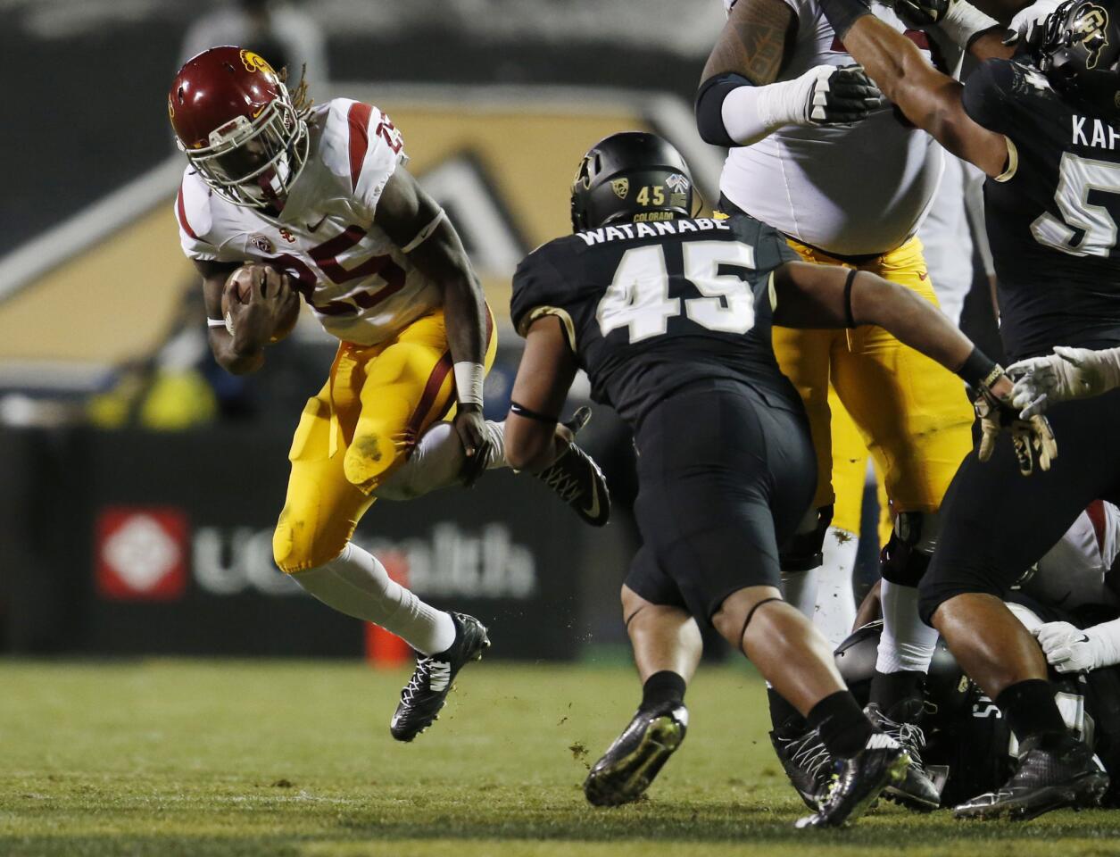 USC running back Ronald Jones II tries to evade Colorado linebacker Grant Watanabe in the first half of their game Friday night in Boulder.
