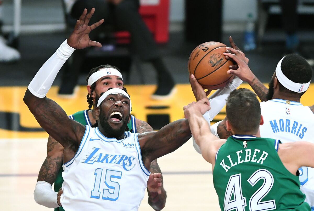 Lakers center Montrezl Harrell grabs a rebound from Mavericks forward Maxi Kleber during their game on Christmas night.