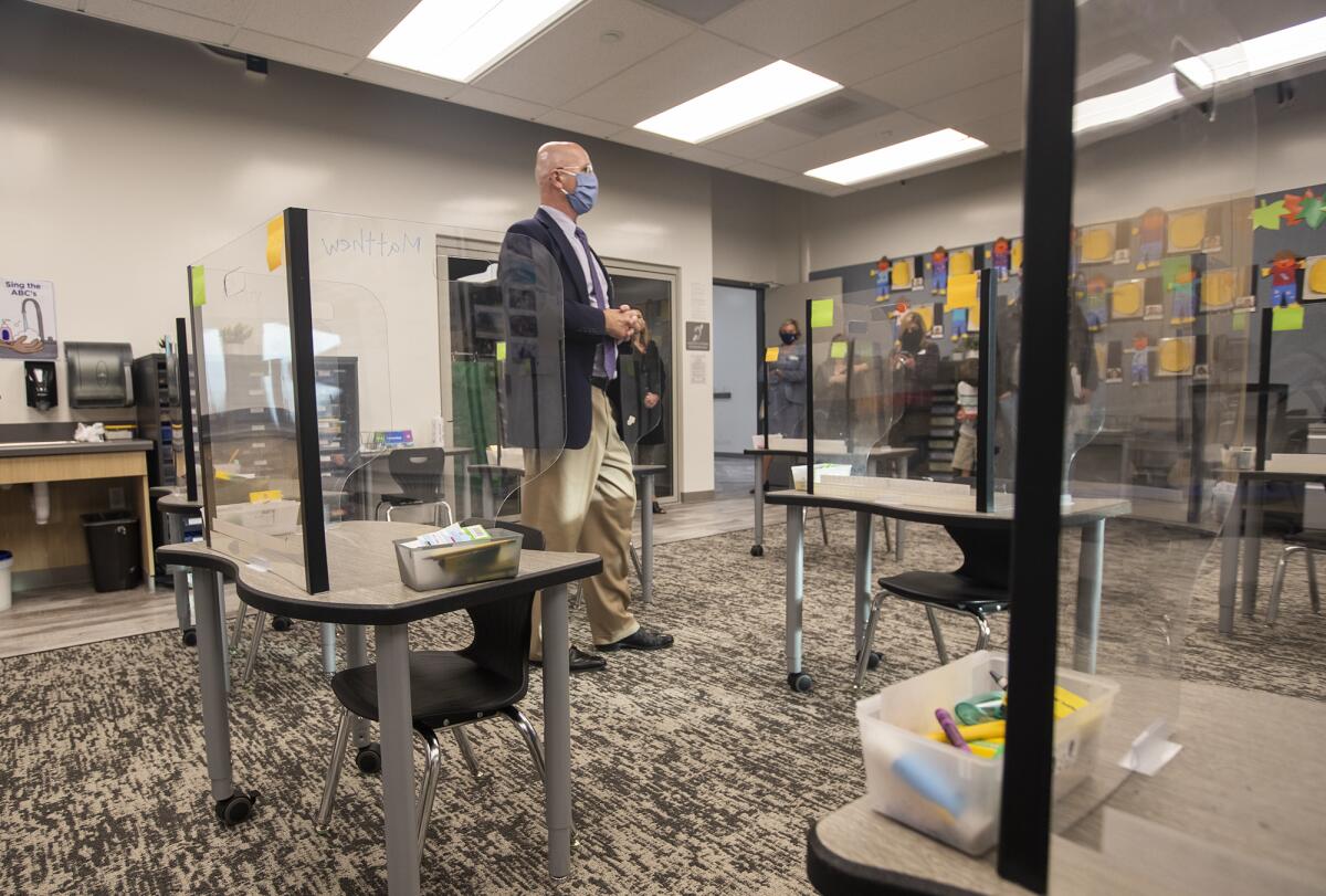 Dr. Michael Conroy, left, the deputy superintendent of the Ocean View School District, gives a tour of a classroom.