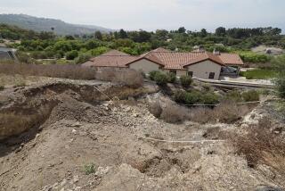 Rancho Palos Verdes, CA - August 01: A view of a large fissure that has opened up since February, damaging a Portuguese Bend home after last winter's heavy rain in Rancho Palos Verdes Thursday, Aug. 1, 2024. Due to continual land movement, the Portuguese bend neighborhood in Rancho Palos Verde could face power shut off. Mike Hong, whose home neighbors a large fissure that has been getting larger and deeper since February, when the area was inundated with heavy rains. He says that water is draining from Rolling Hills homes into Altamira Canyon and directly flowing into the earth and not into the ocean, which is part of a proposed drainage plan. He says lining the canyon would help as rain saturation is one of the contributing factors to movement in the area. The fissure also passes through and through the Palos Verdes Nature Preserve. (Allen J. Schaben / Los Angeles Times)