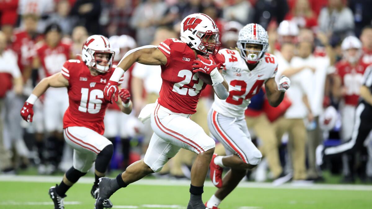 College Football on ESPN - Wisconsin Football RB Jonathan Taylor rocking a Louis  Vuitton mouthpiece ✨🥶
